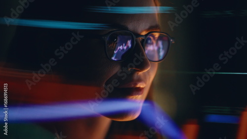 Night woman charts reflection wearing eyeglasses looking computer screen closeup
