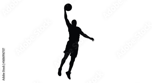 a basketball player silhouette captured mid jump for dunk