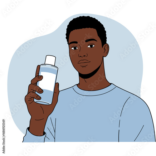 Young Black man holding shampoo bottle in casual blue sweater  