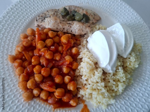 Healthy lunch meal. Chickpea. Chicken fillet, bulgur and yogurt on the plate.