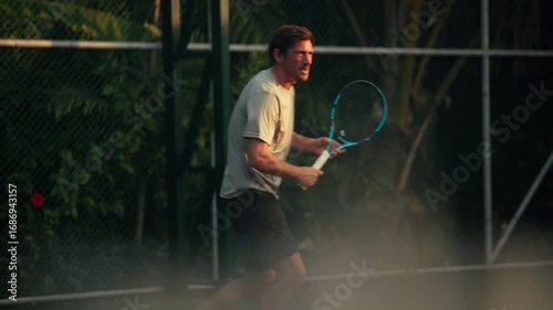 Man playing intense tennis game, demonstrating active and dynamic sports fitness