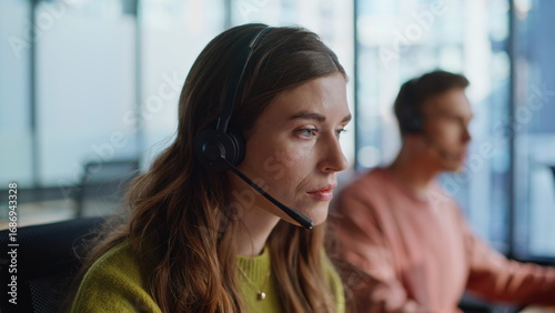 Fotografía Thoughtful support agent listening customer solving request at workplace closeup