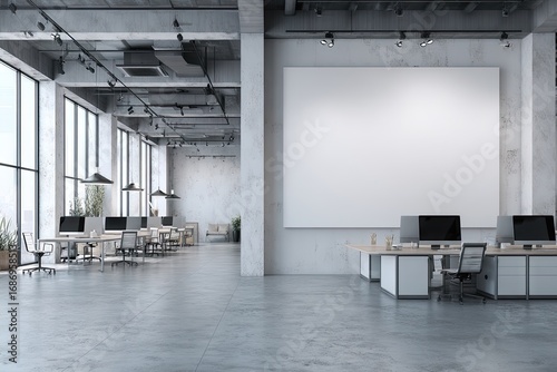 Open-plan modern office space with large blank billboard
