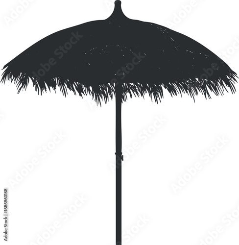 Silhouette of a thatched tropical beach umbrella providing shade and sun protection outdoors
