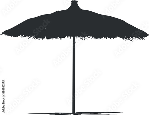 Silhouette of a thatched beach umbrella providing shade on a sunny tropical beach setting