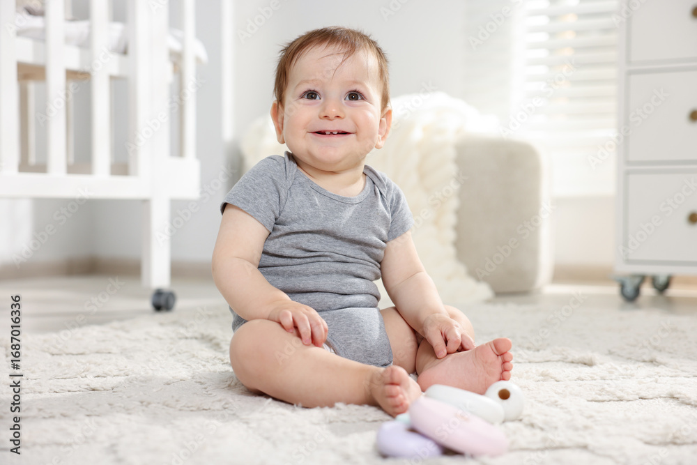 Fototapeta premium Cute little baby playing with toys in room