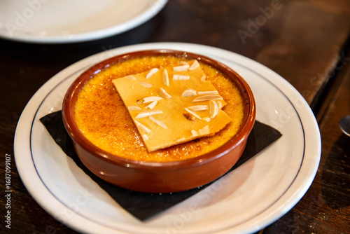Obraz na plátně French crème brûlée with caramelized sugar surface and almond crisp topping serv