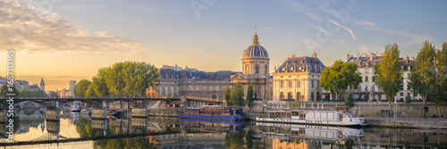 Institut de France at sunrise reflecting on the River Seine in Paris