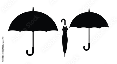 three black umbrellas standing upright against white background