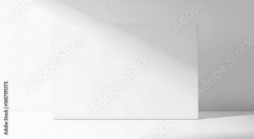 Wallpaper Mural Minimalist White Blank Rectangular Board Leaning Against a Light-colored Wall, Illuminated by Natural Sunlight Creating a Dynamic Diagonal Shadow Across the Surface Torontodigital.ca