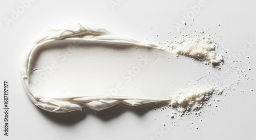 Close up of white cream smear with powdery texture on a bright white background surface