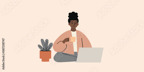 A woman enjoys a moment of relaxation at home, blending productivity and leisure, sipping from a mug while working on her laptop. A plant adds to the homey feel.