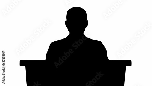 Silhouette of a person sitting at a desk with their back to the viewer against a white background scene