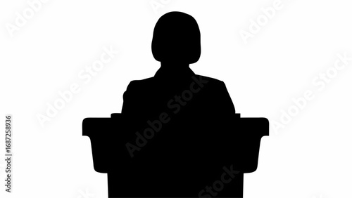 Silhouette of a person standing behind a podium giving a speech in a dark color on a white background