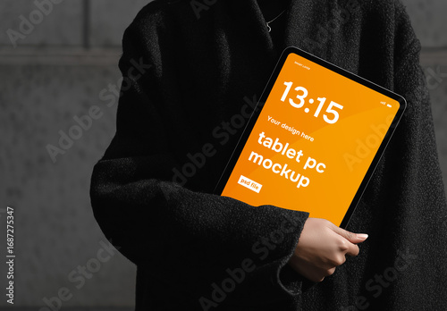 Tablet screen website mockup with woman holding tablet dressed in modern black