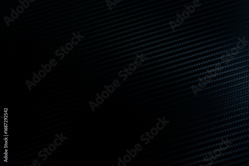 abstract blue black background. close-up of a carbon fiber pattern, black abstract background.