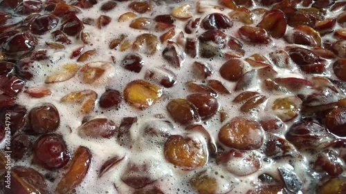 Stirring with a spoon when making homemade plum jam