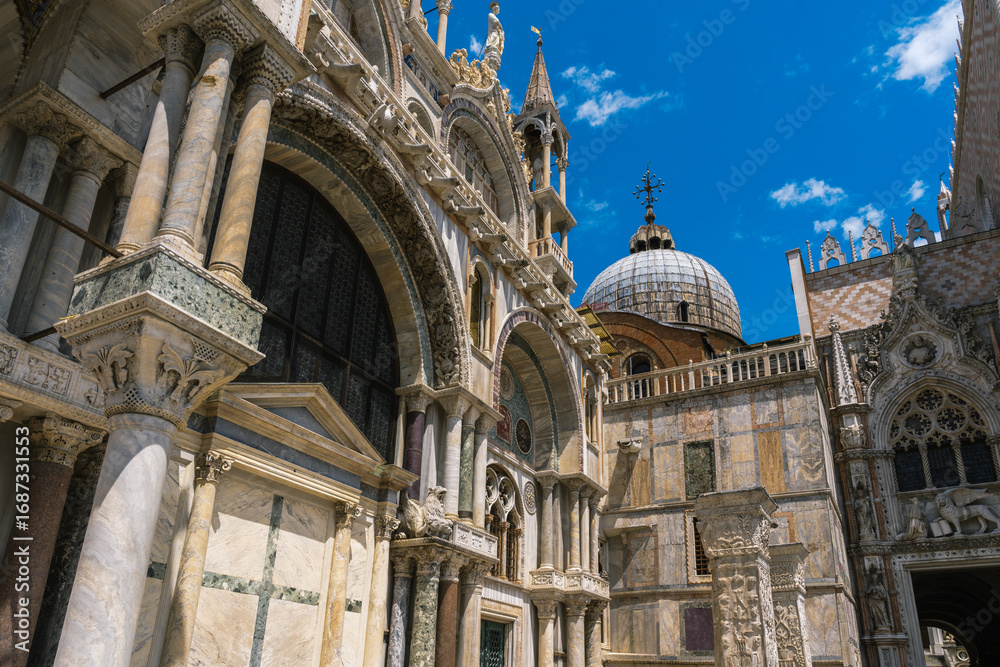 Fototapeta premium Architectural splendor: Ornate facade, pillars, and domes against a vibrant blue sky showcase intricate craftsmanship and classic design.