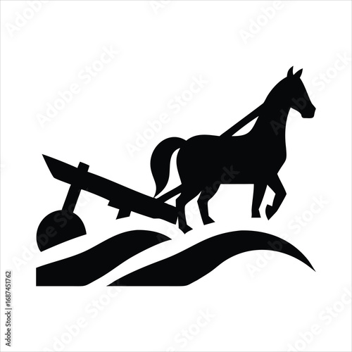 Silhouette of a horse pulling a plow through a field