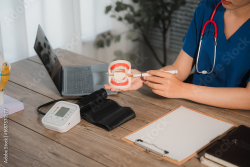 Medical Consultation: A healthcare professional, clad in professional attire, provides a detailed demonstration on dental health using a model.