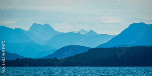 Layers of mountains on the West Coast of Canada on a hazy, early summer morning 