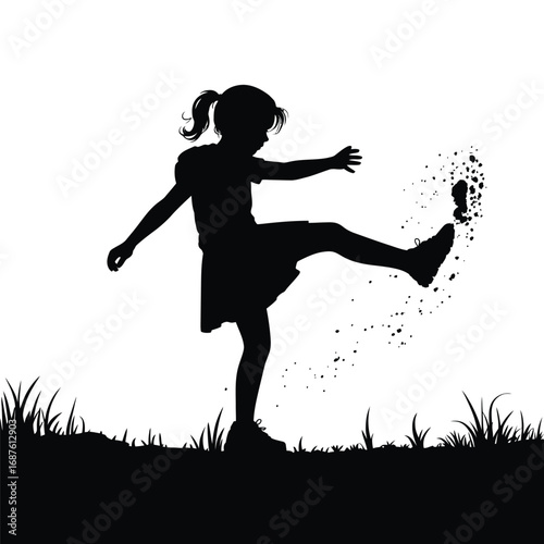 Silhouette of Girl Kicking at Dirt in a Field of Grass