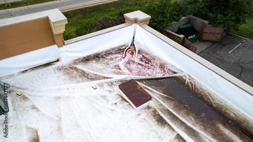 Aerial View of Damaged Commercial Flat Roof with Ponding Water and Stains