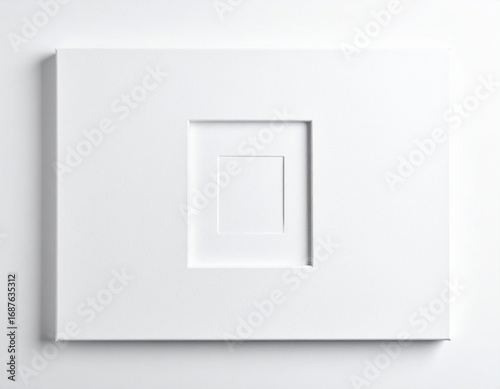 White square sculpture nested within a larger square in a minimalist art studio