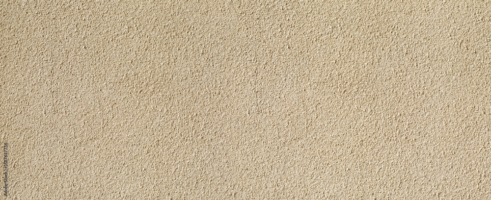 Obraz premium Beige textured plaster wall background providing copy space