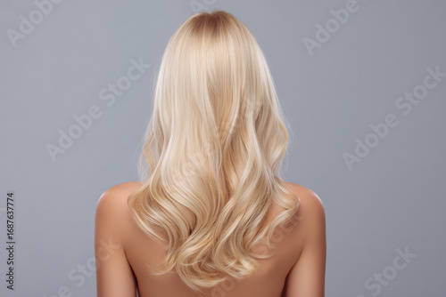 Beautiful long blonde hair flowing down the back against a soft gray background in a minimalist setting Generative AI