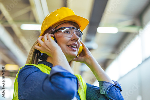 Female Factory Worker Wearing Safety Gear in an Industrial Setting