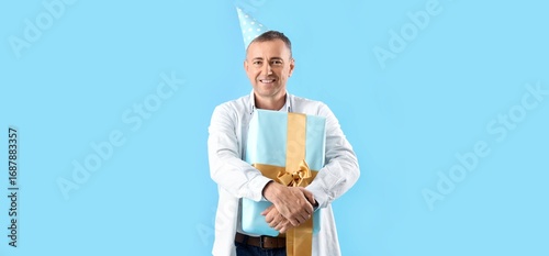 Mature man in party hat and...