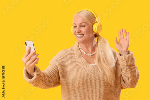 Senior woman in headphones ...