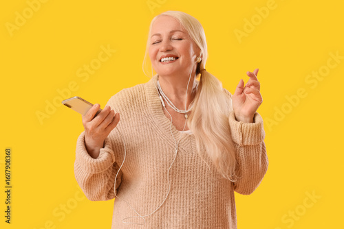Senior woman in headphones ...