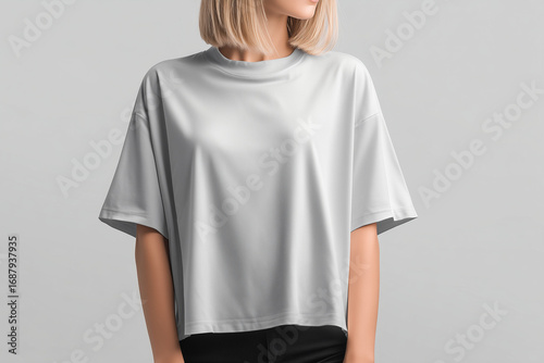 White boxy t-shirt mockup on female model isolated against neutral background