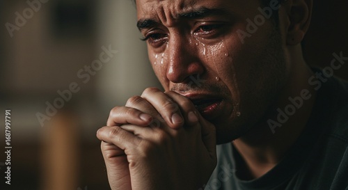 Close of a person praying with tears, expressing faith and devotion to Christ and Lord