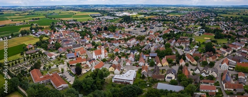 An aerial panorama view above the old town of the city Mertingen on a cloudy summer day in Bavaria, Germany