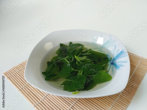 Sayur Bening Bayam or Spinach Clear Soup, isolated on white background 