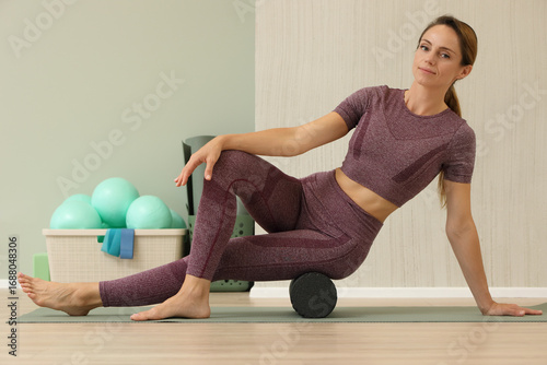 Woman Using Foam Roller for Muscle Recovery Exercise