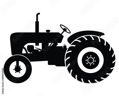 Silhouette of a vintage farm tractor with large rear wheels and smaller front wheels