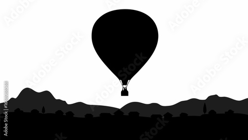 Silhouette of a hot air balloon flying over a landscape with mountains and small buildings in the distance