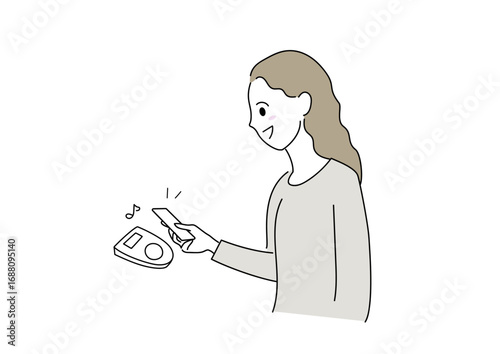 スマホでキャッシュレス決済をしている女性
