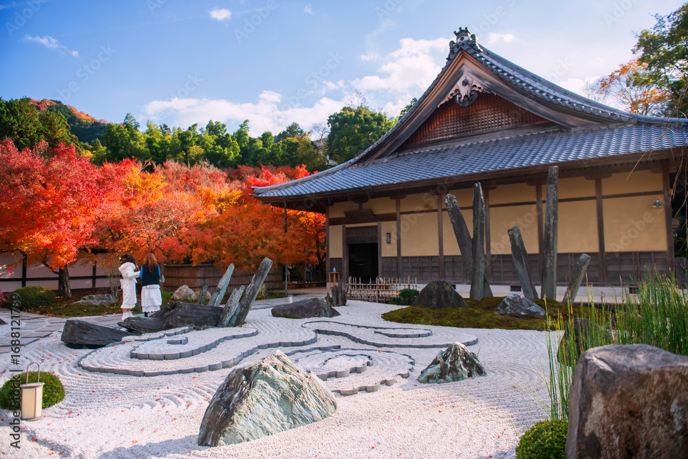 Fototapeta premium Japanese women at rock garden in Enkoji temple with autumn colors, Kyoto