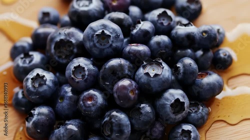 Wallpaper Mural Close-up of blueberries, wet, on a wooden surface with honey drizzled Torontodigital.ca
