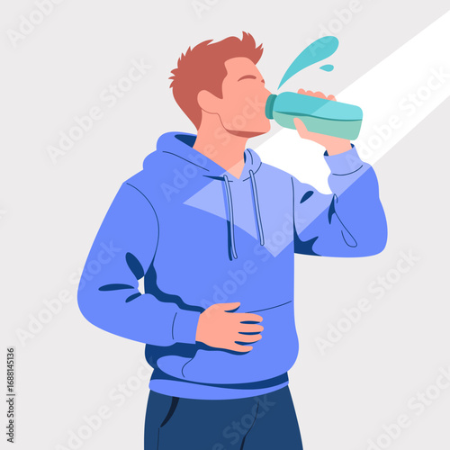 An athletic young man taking a drink from a turquoise water bottle, exuding satisfaction and energy while enjoying a vibrant and refreshing break in a blue hoodie.