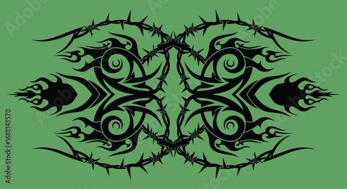 Symmetrical black tribal tattoo design with sharp thorns and flame-like swirls on a solid green background.