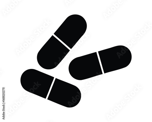 Three black capsule pills scattered on a white surface, isolated image