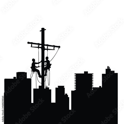 Two linemen working on a utility pole against a city skyline