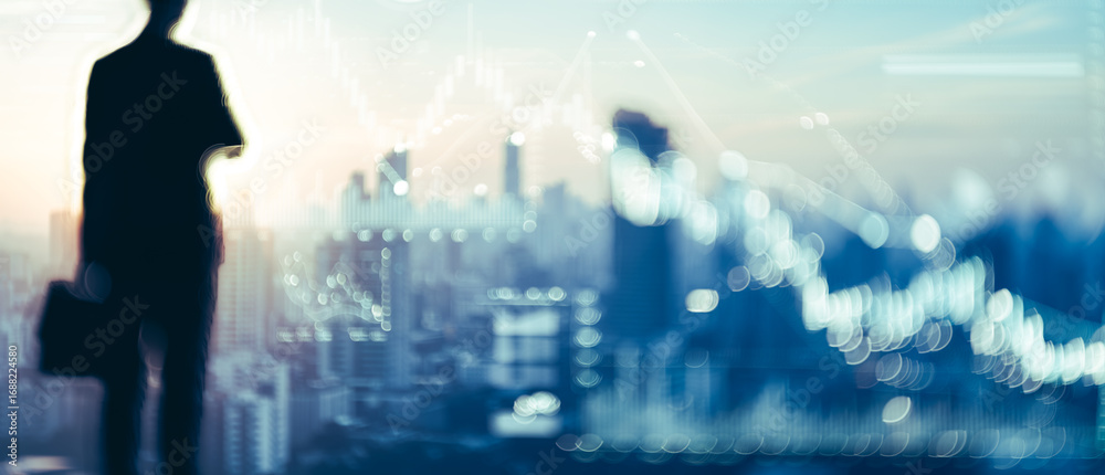 Obraz premium Silhouette of a person with briefcase overlooking a cityscape with financial chart overlay.