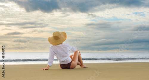 Smiling glance over the shoulder, barefoot on the shoreline, carefree and natural.